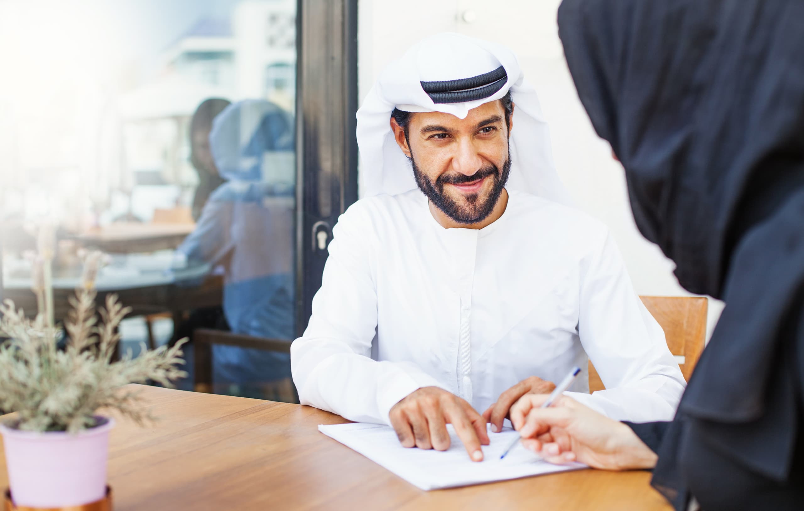 Arab,Man,Giving,Documents,To,Sign,To,A,Woman,In