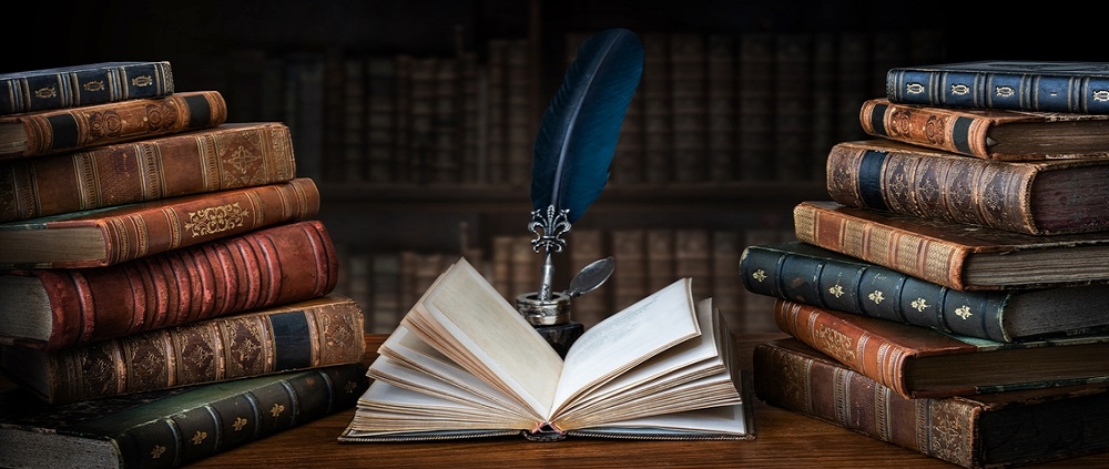 Premium Photo | Books, writing materials, glasses, notebook and alarm clock  on the desktop. black background. learning and self-education concept.  selective focus on foreground.