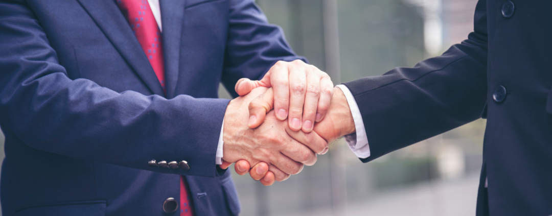 Two men shaking hands on an agreement/promise